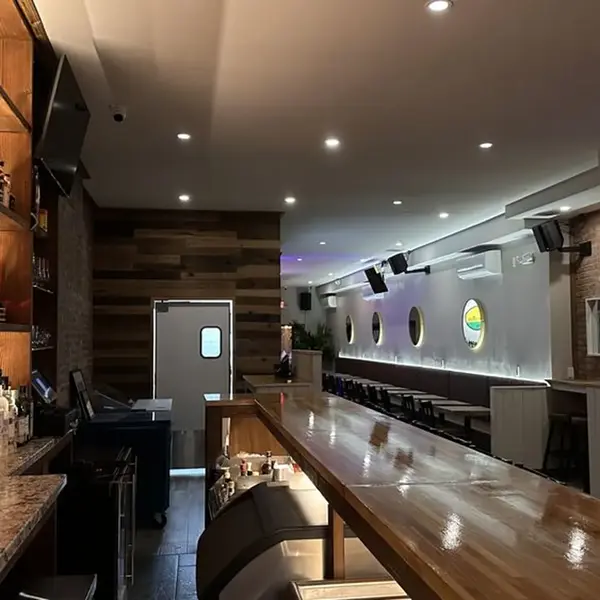 Long view of the bar seating and dining room at Carib Soul BK