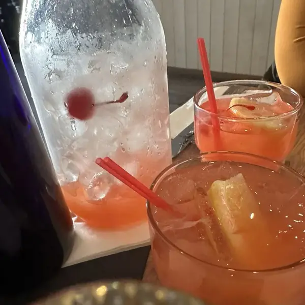 Cocktails and a carafe on a table at Carib Soul BK