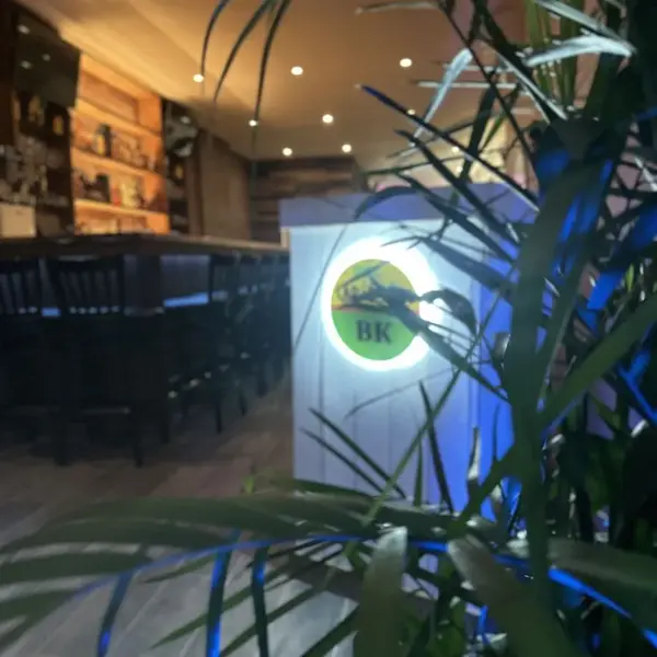 Carib Soul BK entrance with the green and yellow logo sign and palm leaves