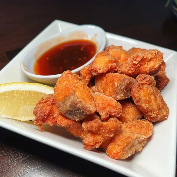 Escovitch salmon bites with sweet chili sauce and lemon at Carib Soul BK