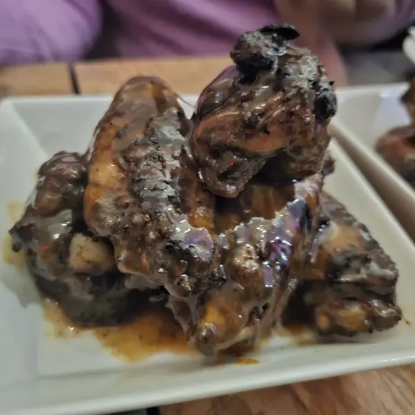 Plate of glazed jerk wings at Carib Soul BK